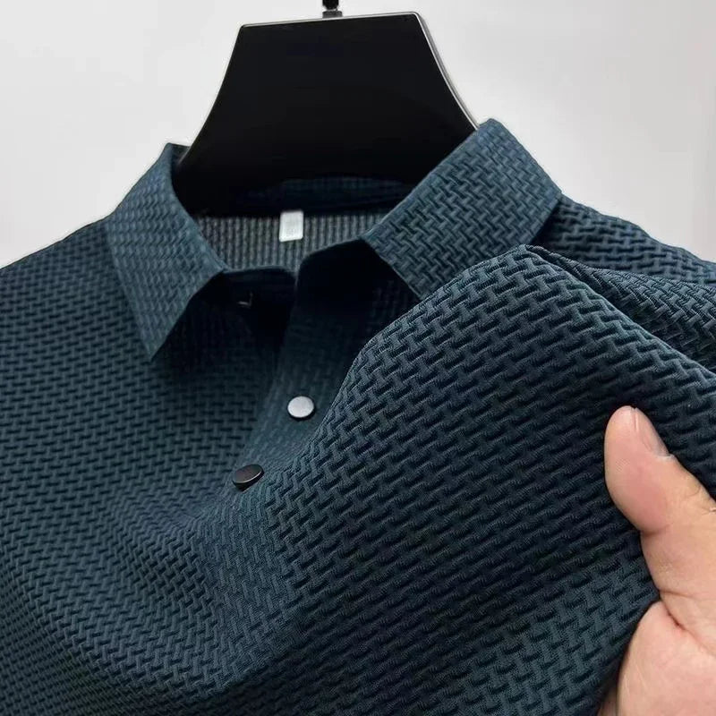 Green textured polo shirt held by a hand against a white background